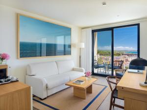 a living room with a couch and a view of the ocean at H10 Imperial Tarraco 4 Sup in Tarragona