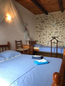 a bedroom with two beds and a table with a lamp at Lo Soulenquo à Fonteilles sur le GR 65 in Golinhac