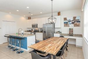 a kitchen with a wooden table and a refrigerator at Fantastic Lakeview Townhome near Disney in Kissimmee