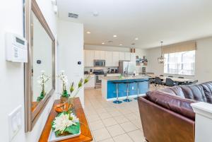 a living room and kitchen with a couch and a table at Fantastic Lakeview Townhome near Disney in Kissimmee