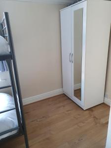 a room with a mirror and a bunk bed at Next to Aintree Golf Course in Aintree