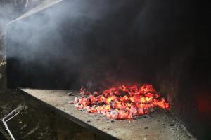a bunch of chickens are cooking on a grill at Casa rural tres regiones in Ontiñena