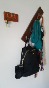 a black bag hanging on a wall with blue hair at Dpto Paraná - Piscina, calefacción y aire acond in Córdoba