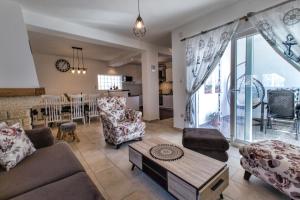 a living room with a couch and a table at Luxury House Cesarica in Cesarica