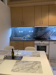 a kitchen with a table with a bottle of wine on it at New luxury apartment in central suburb of Athens in Athens