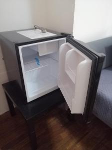 a refrigerator with its door open in a room at B&B Joffre in Messina