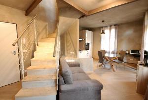 a living room with a staircase and a couch at Vieille maison in Aosta