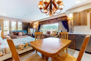 a kitchen and living room with a table and chairs at Shoshone in Big Sky