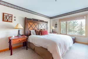 a bedroom with a large bed and a window at Shoshone in Big Sky