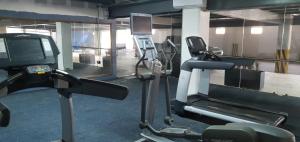 a gym with a treadmill and a tv in it at Hotel San Carlos in La Barca