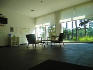 a room with a table and chairs and windows at HI Melgaco - Pousada de Juventude in Melgaço