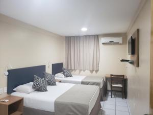 Säng eller sängar i ett rum på Villa Park Hotel Fortaleza - antes Hotel Villamaris