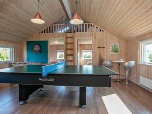 a ping pong table in the middle of a room at 12 person holiday home in Idestrup in Marielyst
