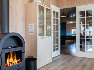 a fireplace in a room with a living room at 12 person holiday home in Idestrup in Marielyst