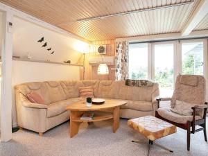 a living room with a couch and a table at 6 person holiday home in Gedsted in Gedsted