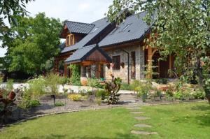 a house with a garden in front of it at Siedlisko Poleski Zakątek in Lejno