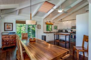 a dining room with a wooden table in a kitchen at Hale Naninoa home in Hanalei