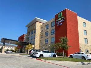 a hotel building with cars parked in front of it at Holiday Inn Express & Suites - Forney by IHG in Forney