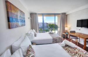 Postel nebo postele na pokoji v ubytování Cairns Plaza Hotel