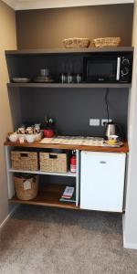 a kitchen with a counter with baskets on it at Grampians B&B in Nelson