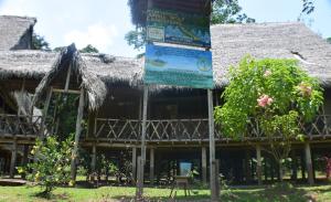 a building with a sign in front of it at Lodge Jungle Wolf Expeditions in Yucuruche