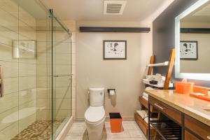 a bathroom with a toilet and a glass shower at Hotel Lexen Newhall & Santa Clarita - Near Six Flags Magic Mountain in Santa Clarita