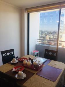 a dining room table with a view of a city at Departamento Freire 1062 in Concepción +31 photos