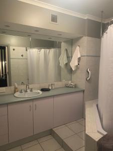 a bathroom with a sink, mirror, and toilet at Waterside Holiday Rentals Unit 31 in Mulwala