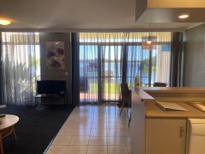 a kitchen and living room with sliding glass doors at Waterside Holiday Rentals Unit 31 in Mulwala