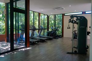 a gym with treadmills and ellipticals in a room with windows at Spectacular Beachfront at veneros fully staffed in Cruz de Huanacaxtle