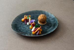 a blue plate with food on a table at Hotel U Kříže in Prague