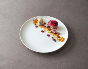 a white plate with some desserts on a table at Hotel U Kříže in Prague