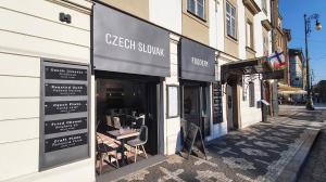 a store front of a restaurant on a street at Hotel U Kříže in Prague