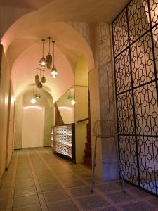a hallway with arches and a table in a building at Hotel U Kříže in Prague