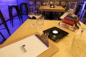 a table with wine glasses and a bottle of wine at Hotel U Kříže in Prague