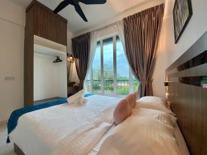a bedroom with a large bed with a large window at Century Suria Aparment Langkawi by Zervin in Kuah