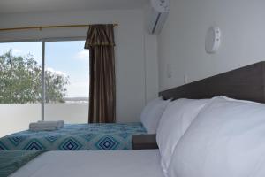 En eller flere senger på et rom på Mare S&M Casa Hostal