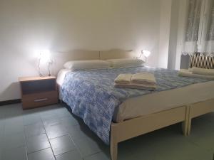 a bedroom with a bed with two towels on it at RES Clara in Padova