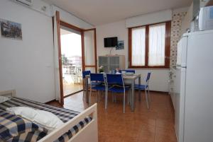 a kitchen and dining room with a table and chairs at Residenza Gardenia in Lignano Sabbiadoro