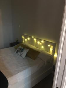 a bedroom with a bed with lights on it at Apartamento Urquijo in Granada