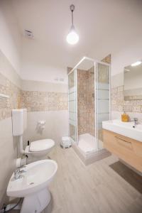 a bathroom with a sink, toilet and bathtub at Casanova Rooms and Apartment to Rent in Cefalù