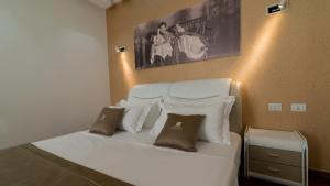 a bedroom with a bed with white sheets and pillows at Deluxe & Executive SPA by Rafaelo in Shëngjin +48 photos