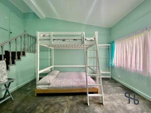 a room with two bunk beds and a staircase at GlenCove Villa by Homesuite' in Kota Kinabalu