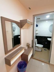 a bathroom with a toilet and a sink and a mirror at Yellow Mansion Hotel Melaka Raya in Melaka +90 photos