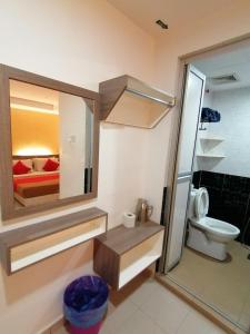 a bathroom with a toilet and a sink and a mirror at Yellow Mansion Hotel Melaka Raya in Melaka