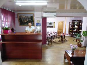 a man sitting at a bar in a restaurant at Na Admirala Makarova in Mykolaiv