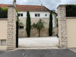 an entrance to a building with a stone wall at Villa Raspail in Ivry-sur-Seine