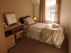 A bed or beds in a room at The Golden Lion Hotel