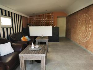 a living room with a couch and a tv at Villa Boho Cherga in Belgrade