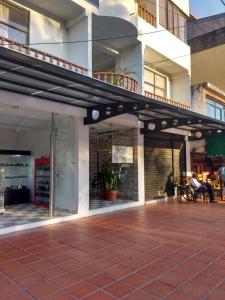 a building with awning on a sidewalk in front at HOTEL LA FONTANA in Yopal